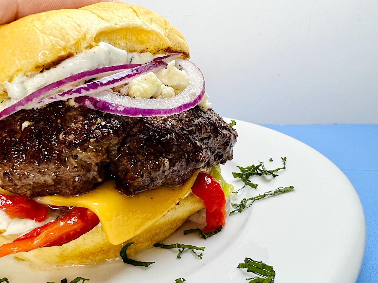 Juicy Lamburgers with Feta, Mint Tzatziki, and Roasted Peppers